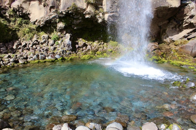 The crystal clear water of Taranaki Falls