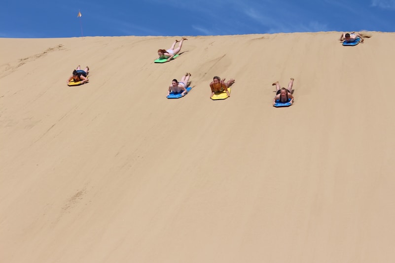 Sand boarding at one of the best beaches in Northland