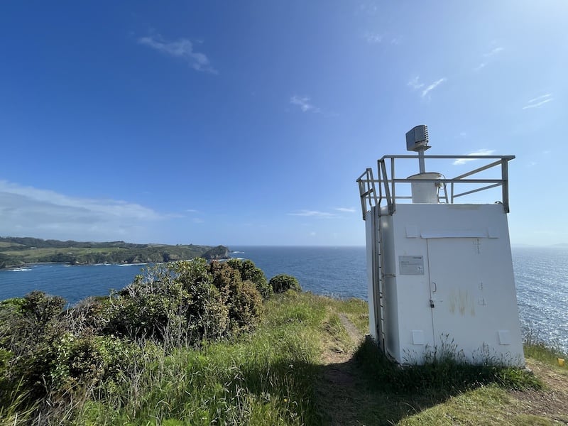 Looking north at the blue ocean with the Tutukaka lighthouse in the foreground