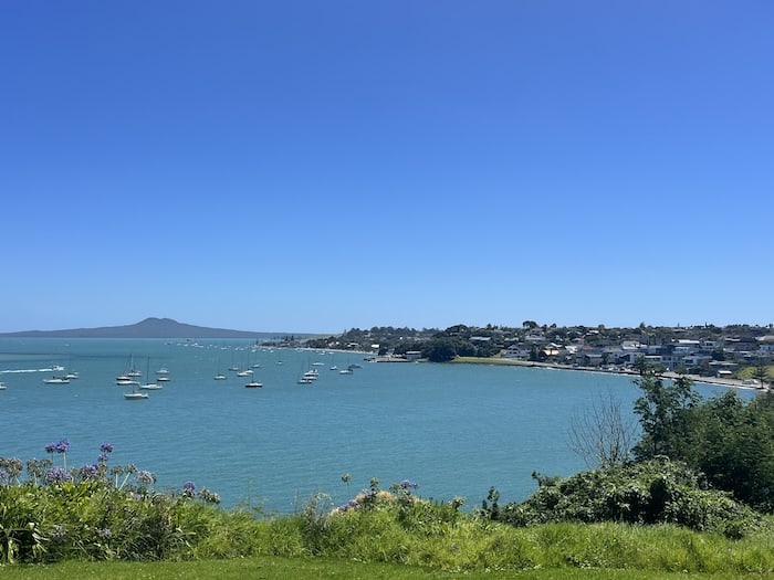 Bucklands Beach as seen from the lookout. With lots of boats in the water and Rangitoto in the background