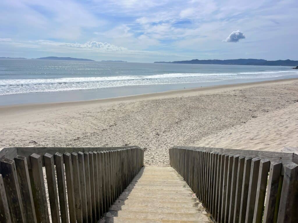 Looking down the wooden stairs that lead to the white sand at the beach