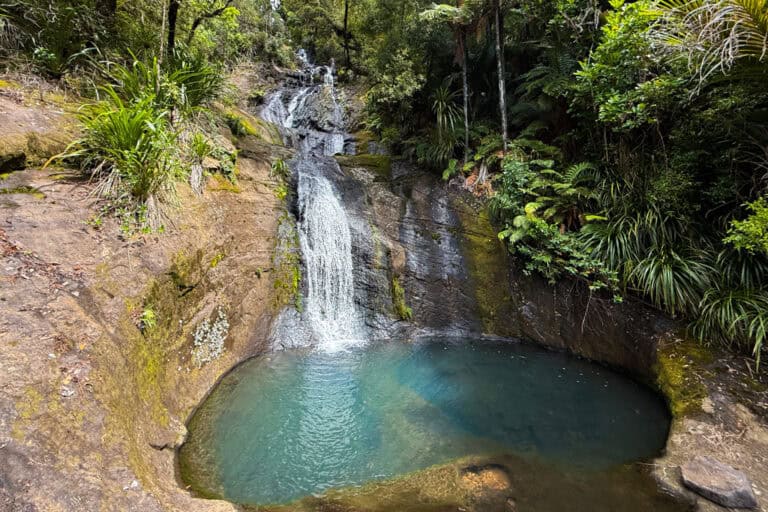 The blue water shines at the base of Fairy Falls