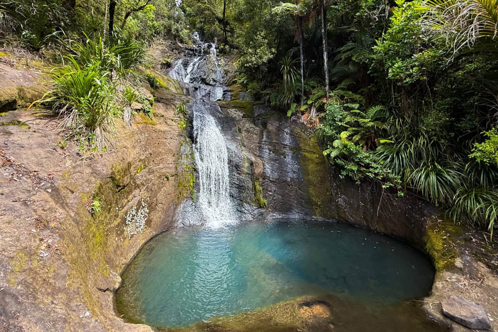 The blue water shines at the base of Fairy Falls