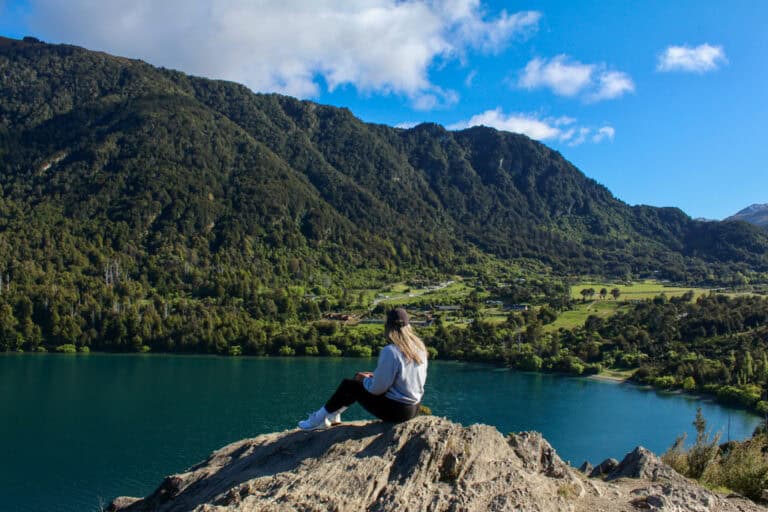 Girl sitting on a rocky lookout looking over Bob's Cove.