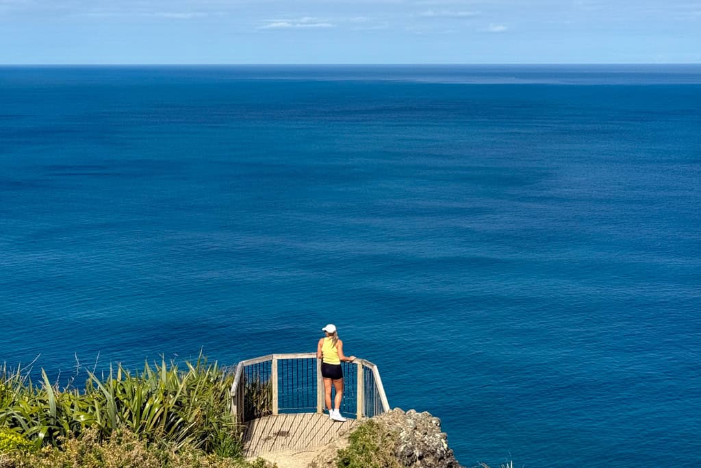 Girl looking out to ocean at the lookout on the Mercer Bay Loop Walk.