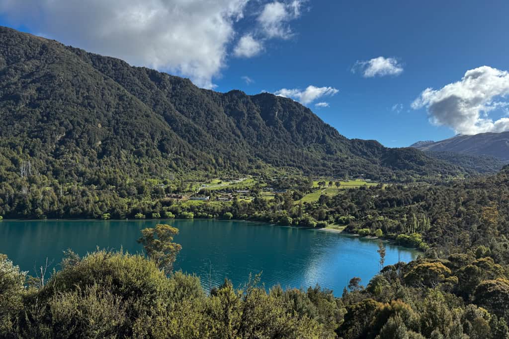 The blue Lake with the green mountains in the background.