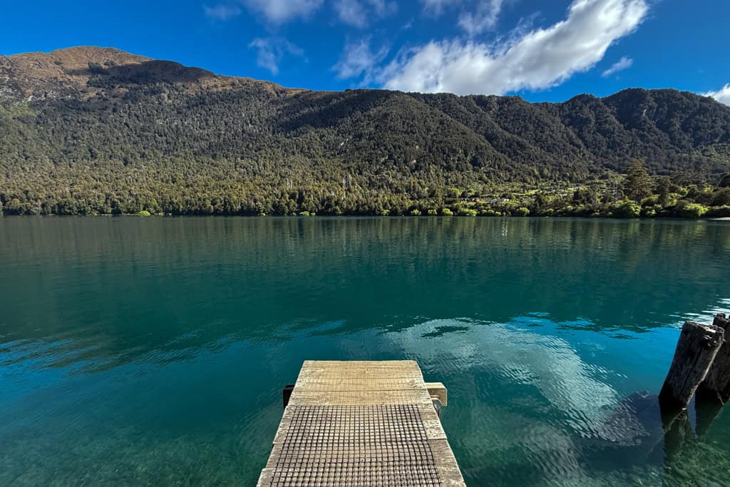 The wharf leading out to the blue water.