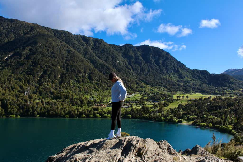 Girl standing at the top of the lookout in Bob's Cove looking out over the lake.