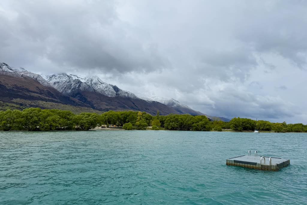 The lake in Glenorchy with mountains in the background on a cloudy day.