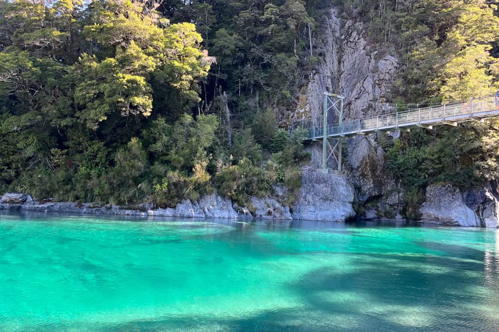 The bright turquoise water at the Blue Pools with the famous swing bridge in the background.