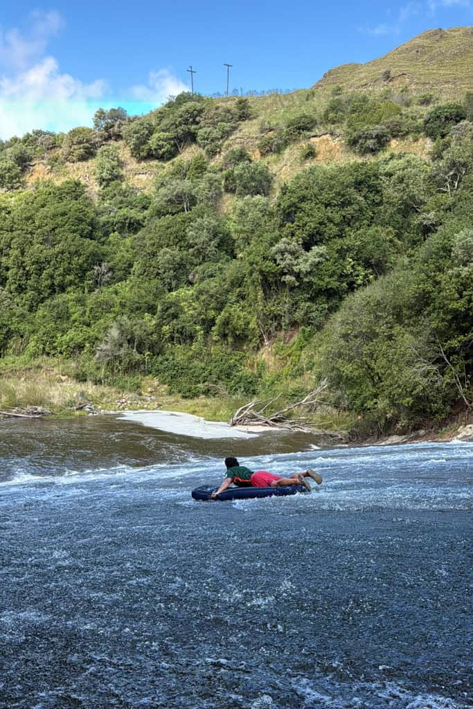 Man slidding down the Rere Rockslide in Gisborne.