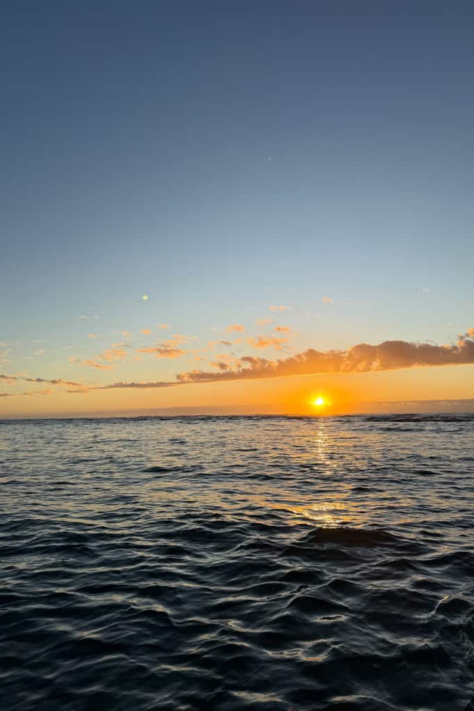 The sun rising up over the ocean.