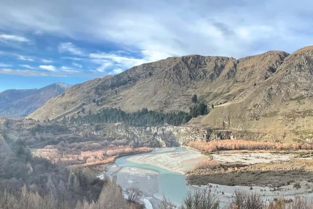 The Shotover River winds through the valley beneath the Top 10 Holiday Park.