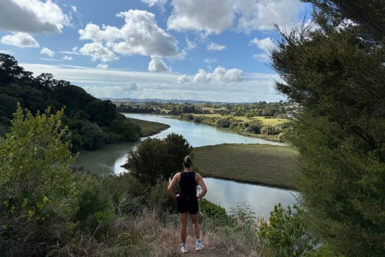 Woman standing at the lookout at the Mangemangeroa Reserve looking down at the estuary.