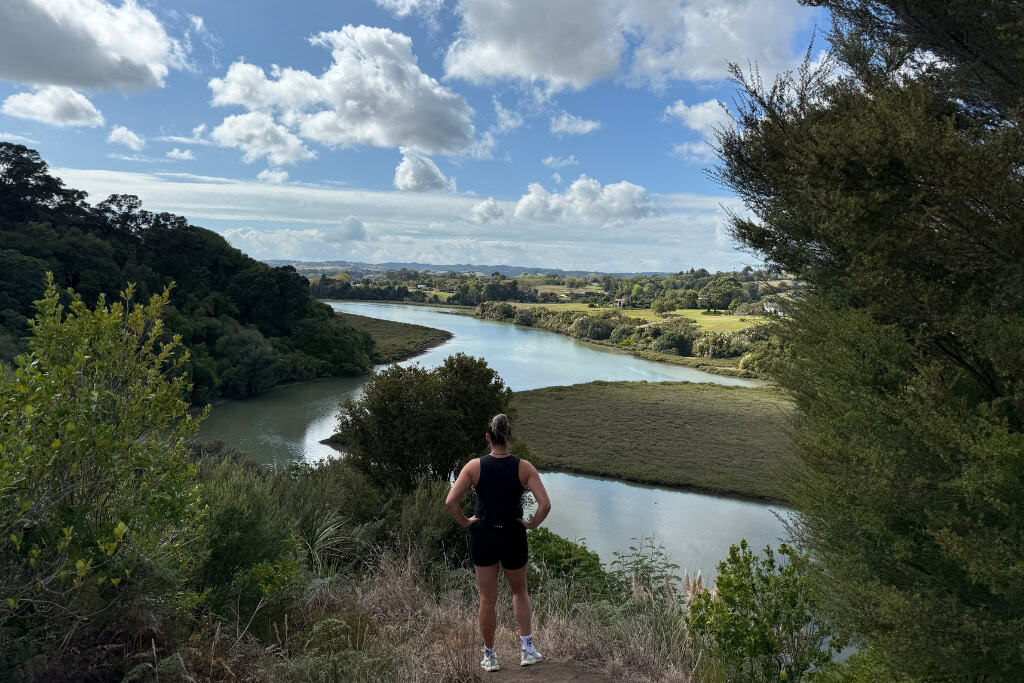 Woman standing at the lookout at the Mangemangeroa Reserve looking down at the estuary.