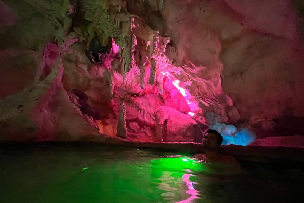 Coloured lights shining in the cave pool.