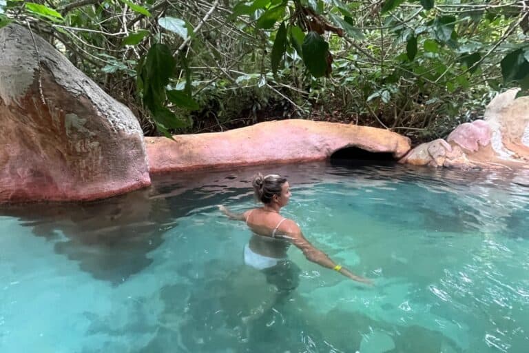 Woman swimming in the blue water at the Lost Spring.