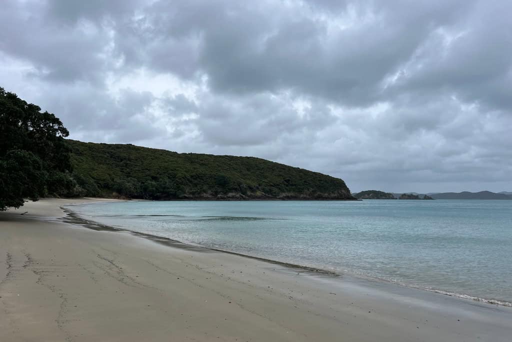 The calm beach on the island on a cloudy day.
