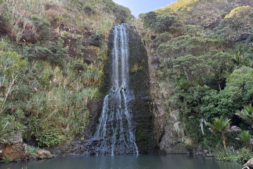 Karekare Falls with the water falling into the pool below.