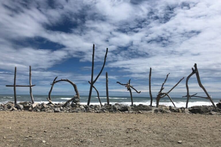 The driftwood Hokitika sign on the beach that is a must visit.