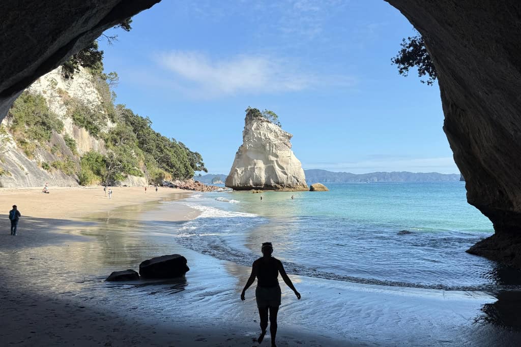 Person walking through the archway at Cathedral Cove.