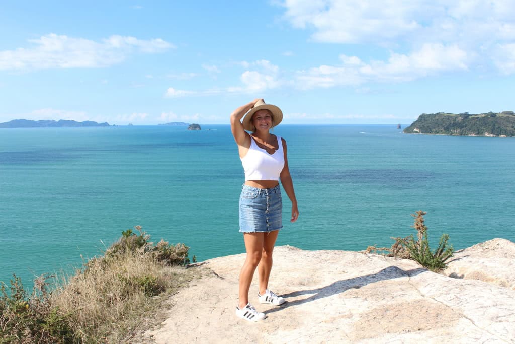 Woman standing on the edge of the cliff at Shakespeare Cliff Lookout.