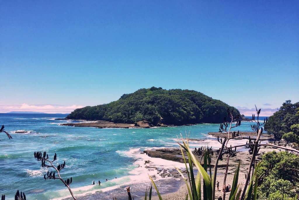 The view of Goat Island with waves crashing around it.