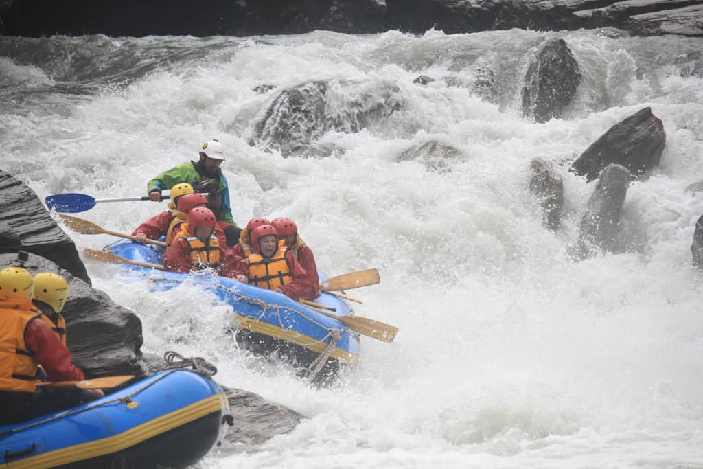 A group of people going down the rapids with Queenstown Rafting.