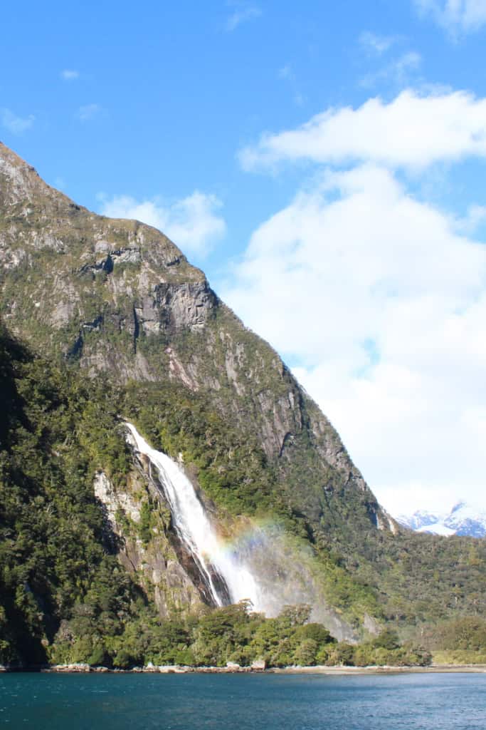 A tall waterfall surrounded by mountains.