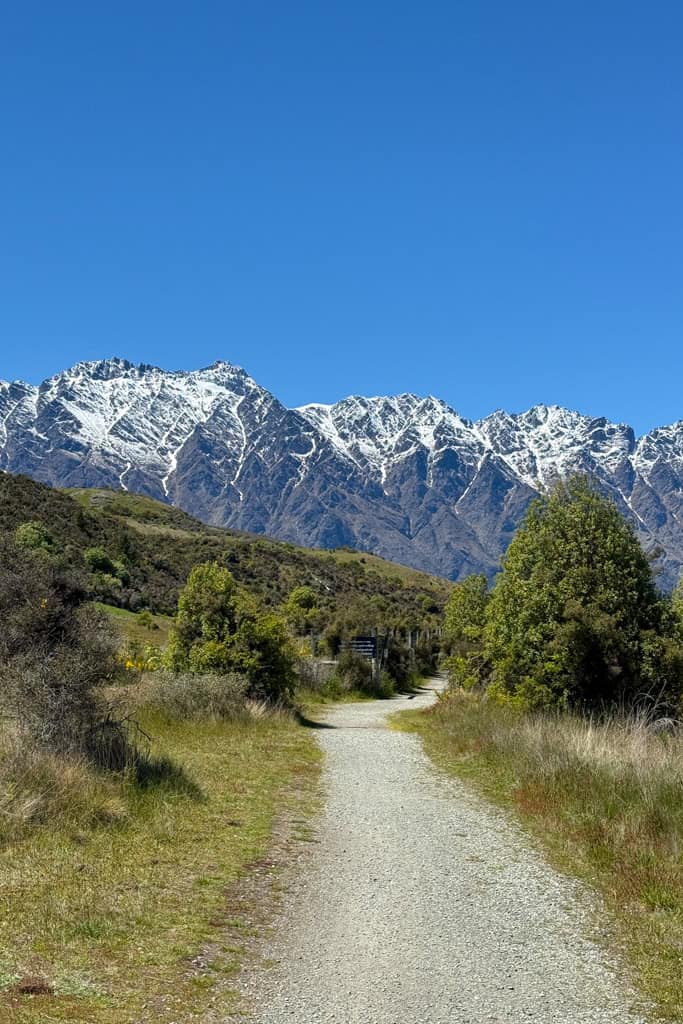 The gravel track winding its way towards the snow covered mountains.