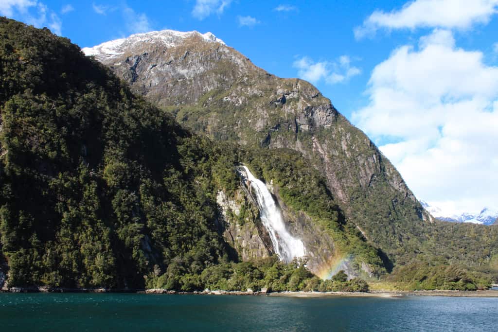 Bowen Falls surrounded by the tall mountains int he Milford Sound.